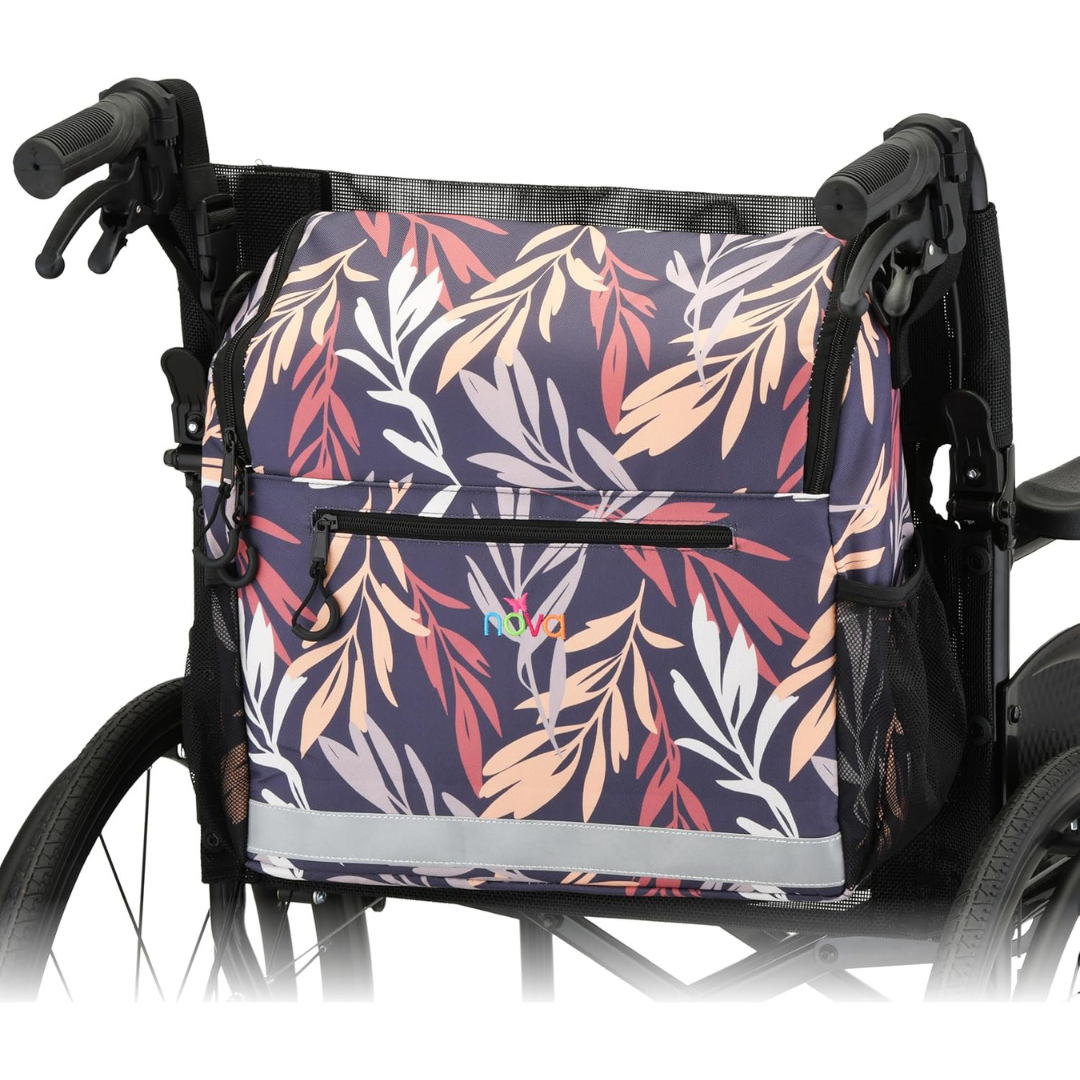 The NOVA Wheelchair Bag with Cup Holder features a colorful leaf pattern in pink, purple, and beige, a waterproof design, front zipper pocket, and attaches to the backrest for convenient and stylish wheelchair storage.